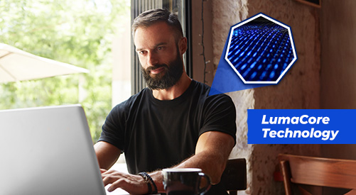 Man working at his computer wearing Nautilus Energy Tee